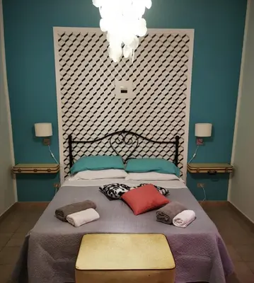 a bedroom with a large bed with pillows on it at Alter Ego in Lascari