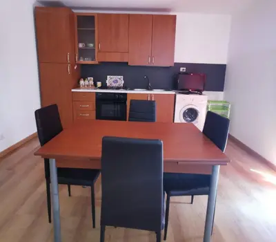 a kitchen with a wooden table and chairs at Alter Ego in Lascari