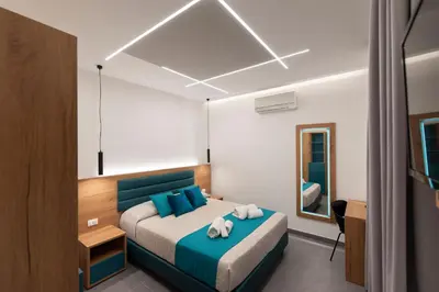 a bedroom with a bed with two teddy bears on it at Room & Breakfast Aloe in San Vito lo Capo