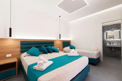 a bedroom with two beds with blue and white at Room & Breakfast Aloe in San Vito lo Capo