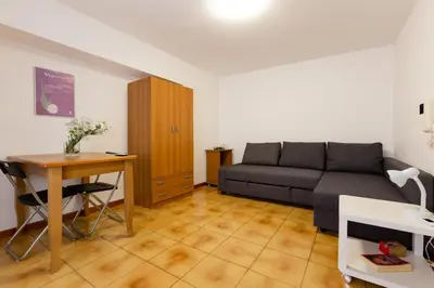 a living room with a couch and a table at GuestHost - Palermo Functional Studio in Palermo