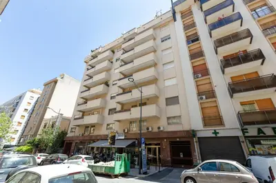 a tall building with cars parked in front of it at GuestHost - Palermo Functional Studio in Palermo