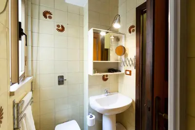 a small bathroom with a sink and a toilet at GuestHost - Palermo Functional Studio in Palermo