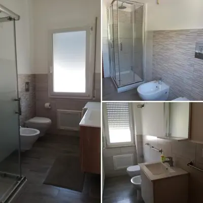 a bathroom with two toilets and a sink and a shower at Casa Vacanze Aurora Boreale in Alcamo Marina