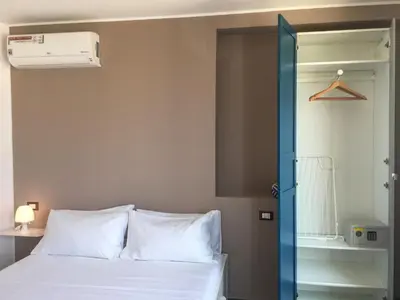 a bedroom with a bed with white pillows at Case Vacanza Calamaro in Trabia