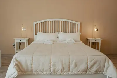 a white bed with two towels on top of it at B&B Matteo Bonello - Fianco Cattedrale in Palermo