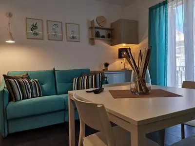 a living room with a table and a couch at Mizzika Vacanze in Castellammare del Golfo