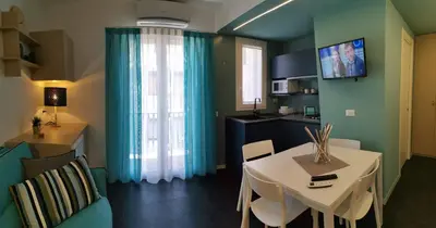 a living room with a table and a dining room at Mizzika Vacanze in Castellammare del Golfo