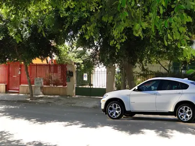 a white car parked on the side of a street at Appartamenti Cavarretta Seminterrati in Mondello