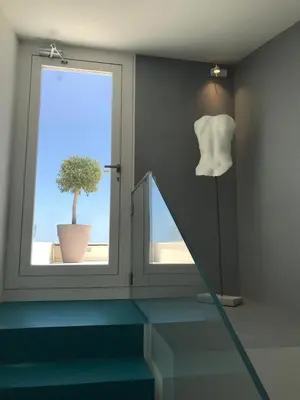 a room with a window and a potted plant at Unìco Boutique Hotel d'Arte in Mondello
