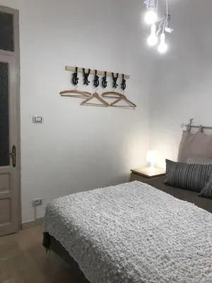 a white bedroom with a bed and a couch at Cappuccini Green Relax in Carini