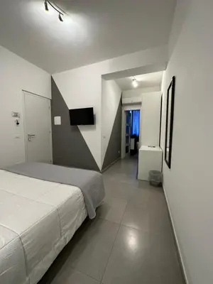 a bedroom with a bed and a television in it at Le Tre Rose in Terrasini