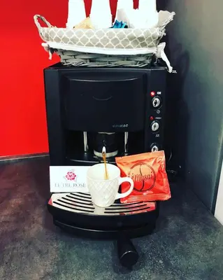 a microwave with a coffee cup and a basket on it at Le Tre Rose in Terrasini