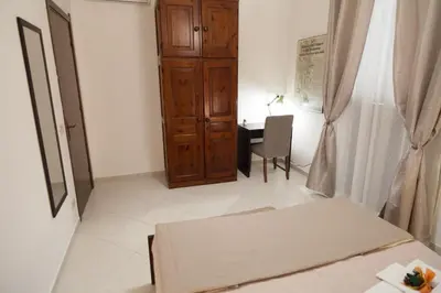 a bedroom with a bed and a desk in a room at Casa Benzo in Palermo