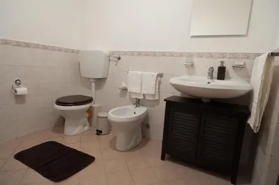 a bathroom with a toilet and a sink at Casa Benzo in Palermo