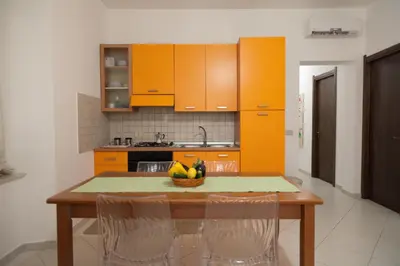a kitchen with a table with a bowl of fruit on it at Casa Benzo in Palermo