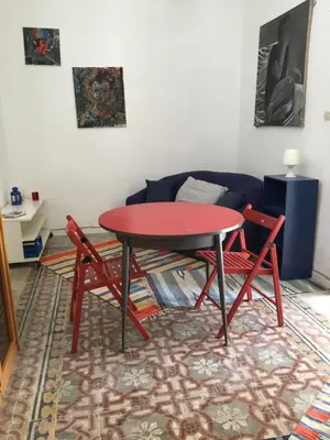 a room with a table and two chairs and a couch at Al Baglio low cost in Palermo