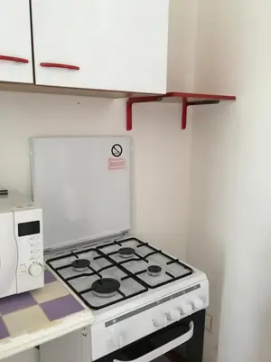 a kitchen with a stove and a microwave at Al Baglio low cost in Palermo