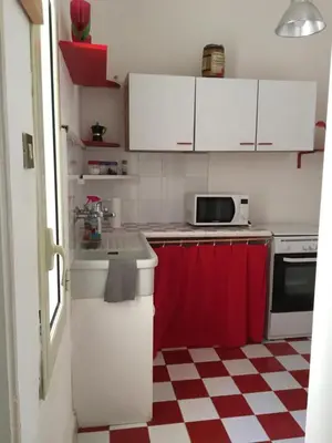 a kitchen with a red and white checkered floor at Al Baglio low cost in Palermo