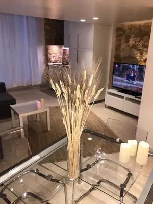 a living room with a glass table and a tv at La Vecchia Stalla in Palermo