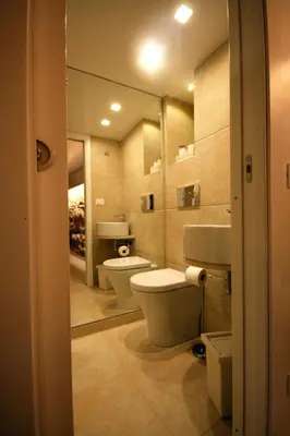 a bathroom with two toilets and a mirror at La Vecchia Stalla in Palermo