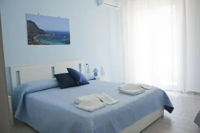 a bedroom with a blue bed with towels on it at B&B d'Orleans in Palermo