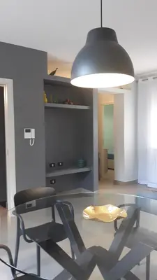 a dining room with a glass table and a chair at ZE-VI HOME in Santa Flavia
