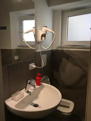 a white sink in a bathroom with a window at Like Home Palermo in Palermo