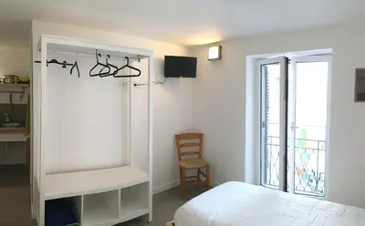a bedroom with a bed and a chair and a window at Like Home Palermo in Palermo