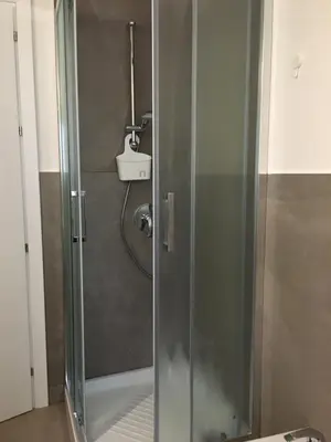 a shower with a glass door in a bathroom at Like Home Palermo in Palermo