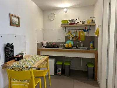 a small kitchen with a table and a sink at Like Home Palermo in Palermo