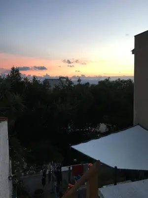 a view of a sunset from the balcony of a building at Casa Escape in Terrasini