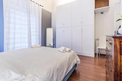 a bedroom with a bed and white cabinets at Casa Valire in Palermo