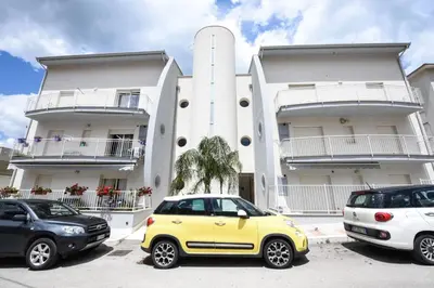 a yellow car parked in front of a building at Appartamento 