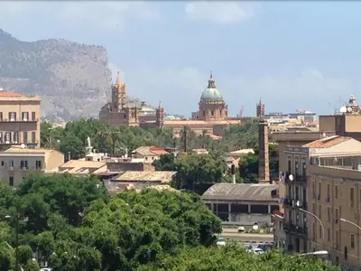 a view of a city with a mountain in the background at Giù a Palermo in Palermo