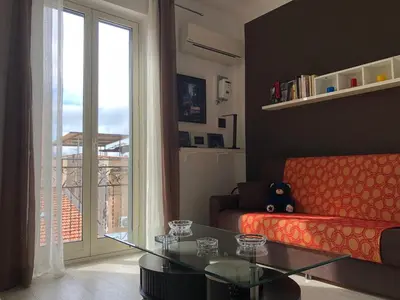 a living room with a couch and a glass table at Giù a Palermo in Palermo