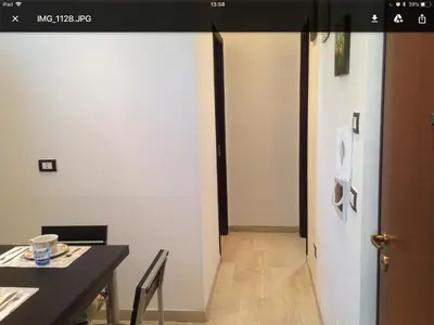 a kitchen with a table and a woman in the mirror at Giù a Palermo in Palermo