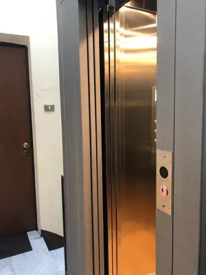 a stainless steel refrigerator in a hallway next to a door at Giù a Palermo in Palermo