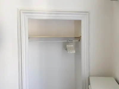 a white door with a shelf in a room at FraLePorte in Palermo