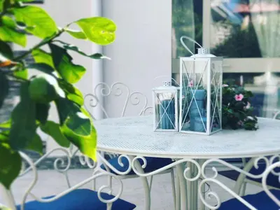 a table with two candles and a potted plant on it at Il Sole di Mondello in Mondello