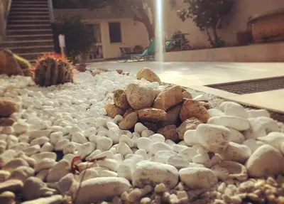 a pile of rocks in a yard with stairs at Il Sole di Mondello in Mondello