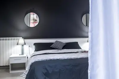 a bedroom with a bed with two mirrors on the wall at Amarillo in Palermo