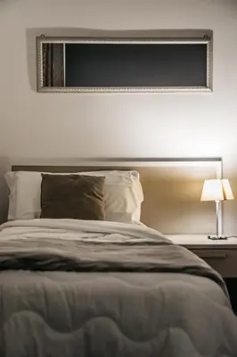 a bedroom with a bed with a mirror on the wall at Amarillo in Palermo