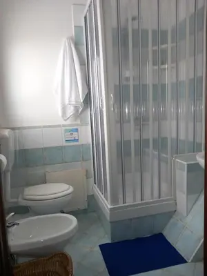 a bathroom with a toilet and a shower at A casa SCALILLA in Palermo