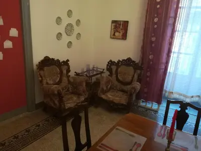 a living room with two chairs and a table at Casa in palazzo Graffeo Sven in Palermo