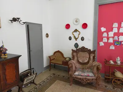 a living room with a chair and a red wall at Casa in palazzo Graffeo Sven in Palermo