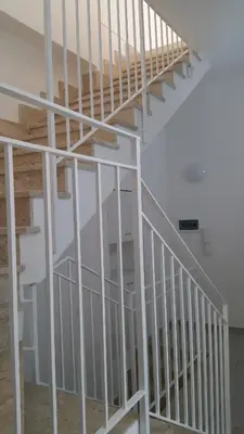 a white spiral staircase in a white room at CASA VACANZE DEL GOLFO 2 in Castellammare del Golfo