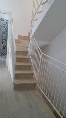 a staircase in a home with white railings at CASA VACANZE DEL GOLFO 2 in Castellammare del Golfo