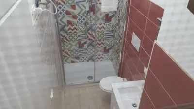 a bathroom with a toilet and a sink and a mirror at CASA VACANZE DEL GOLFO 2 in Castellammare del Golfo