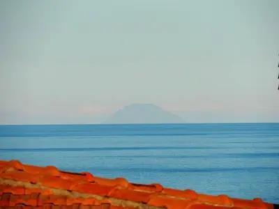 a view of the ocean with a mountain in the background at Villa Flore in Casteldaccia